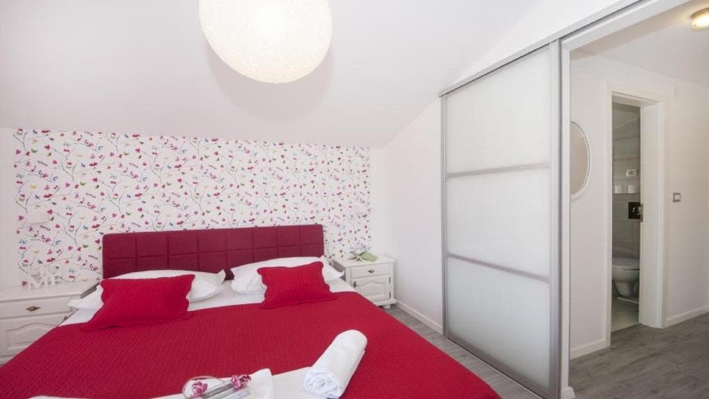 Snježana — second bedroom with floral wallpaper, Angela Apartments Baška Voda